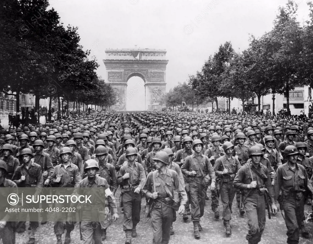 World War II: American troops marching down the Champs Elysees celebrating liberation in Paris, France, September 1944.