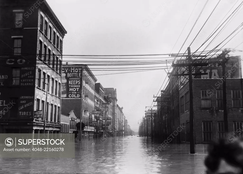 The Great Flood of 1913 was Ohio's greatest weather disaster of the early 20th century. Photo shows flooded warehouses Elm St., looking north, Cincinnati, Ohio. A cropped head of a woman is in lower right (BSLOC_2017_17_94)