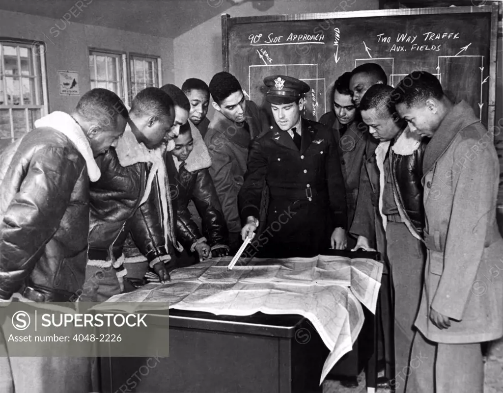 Tuskeegee, Alabama: The U.S. Army's first all-Black air unit, the 99th Pursuit Squadron, instructed be Lt. Donald B. McPhereson. From left: Leeuel R. Custis, Mac Ross, Charles, DeBow, Frederick H. Moore, C.H. Flowers, Jr., George Levi Knox, Lee Rayford, Sherman W. White, Jr., George S. Roberts, and James B. Knighten, 1/23/42.