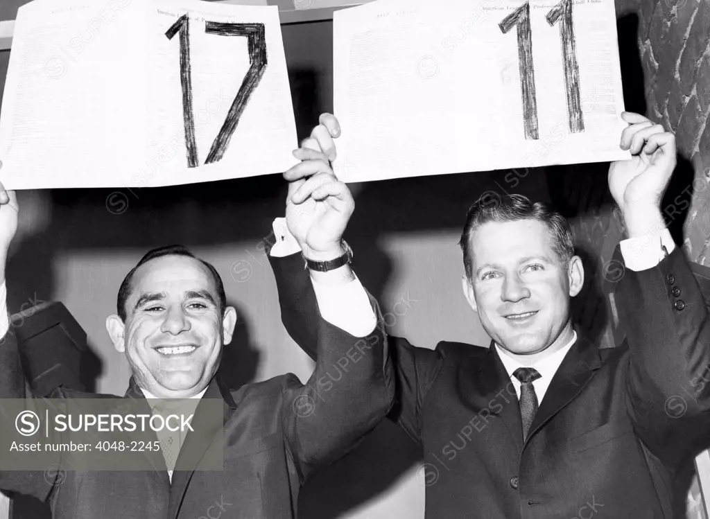 Yogi Berra and Whitey Ford hold up their 17th and 11th contracts with the Yankees, respectively, 1962