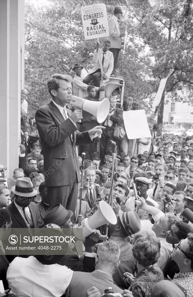 Negro demonstration in Washington D.C.,  Attorney General Robert F. Kennedy (with megaphone) speaking to a crowd outside the justice department, by Warren K. Leffler, June 14, 1963.