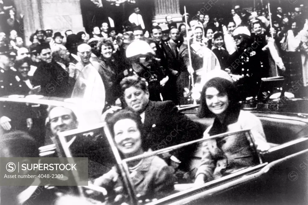 John F. Kennedy motorcade, Dallas, Texas. Photograph shows a close-up view of President and Mrs. Kennedy and Texas Governor John Connally and his wife. Victor Hugo King, photographer. November 22, 1963
