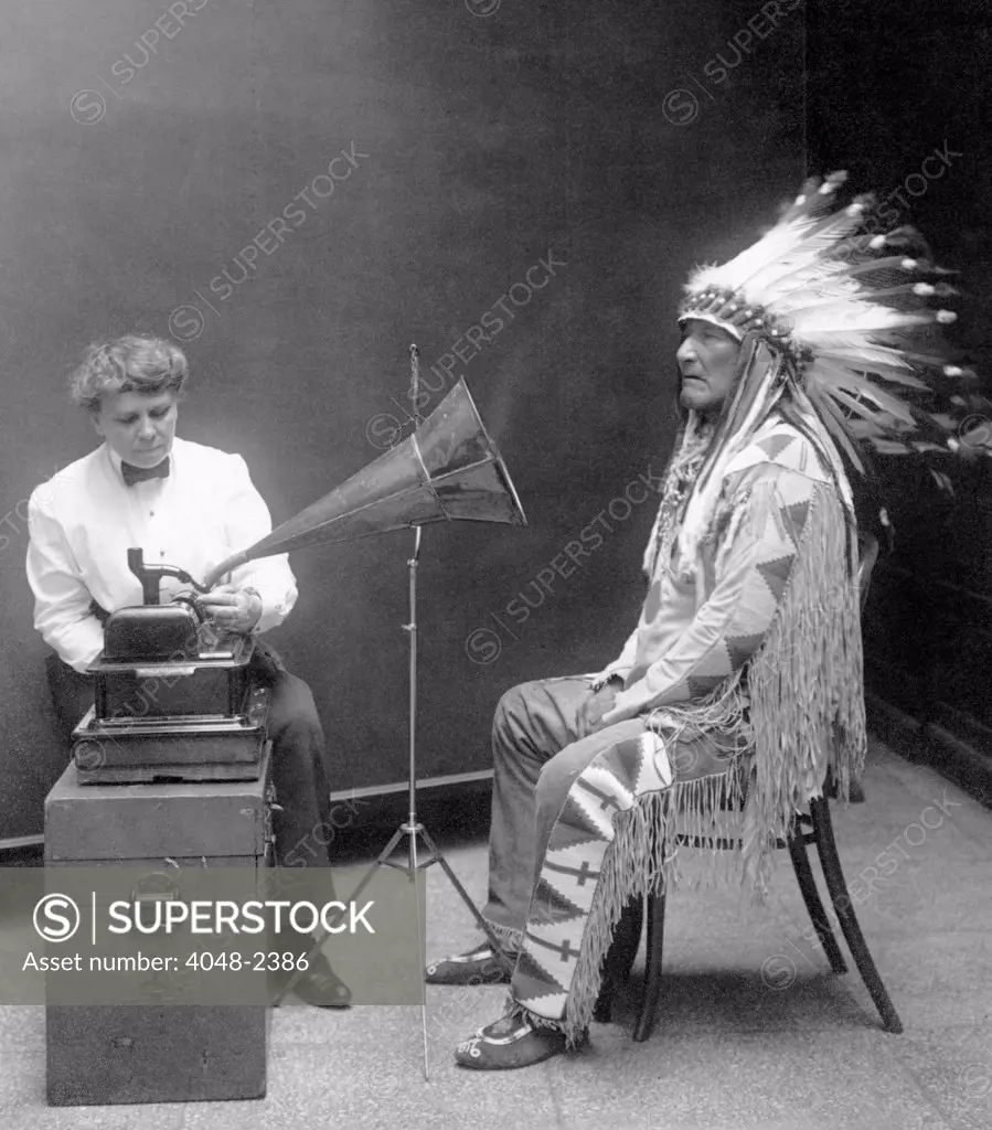 Native American having his voice recorded. Original caption reads: 'Piegan Indian, Mountain Chief, having his voice recorded by ethnologist Frances Densmore', 1916.