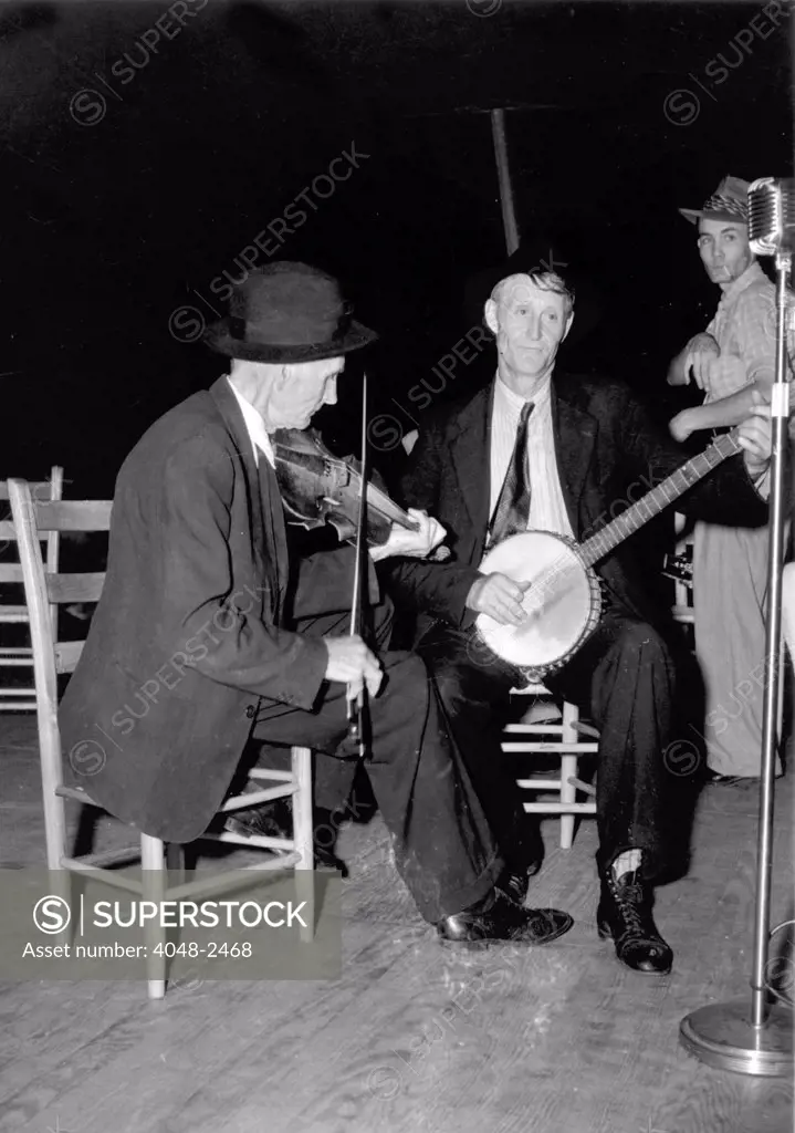 R. J. Boyd, playing fiddle, and Millard Garrett, playing banjo, both from Sandy Mush, North Carolina, at the the Mountain Music Festival, Asheville, North Carolina, 1938-1950.