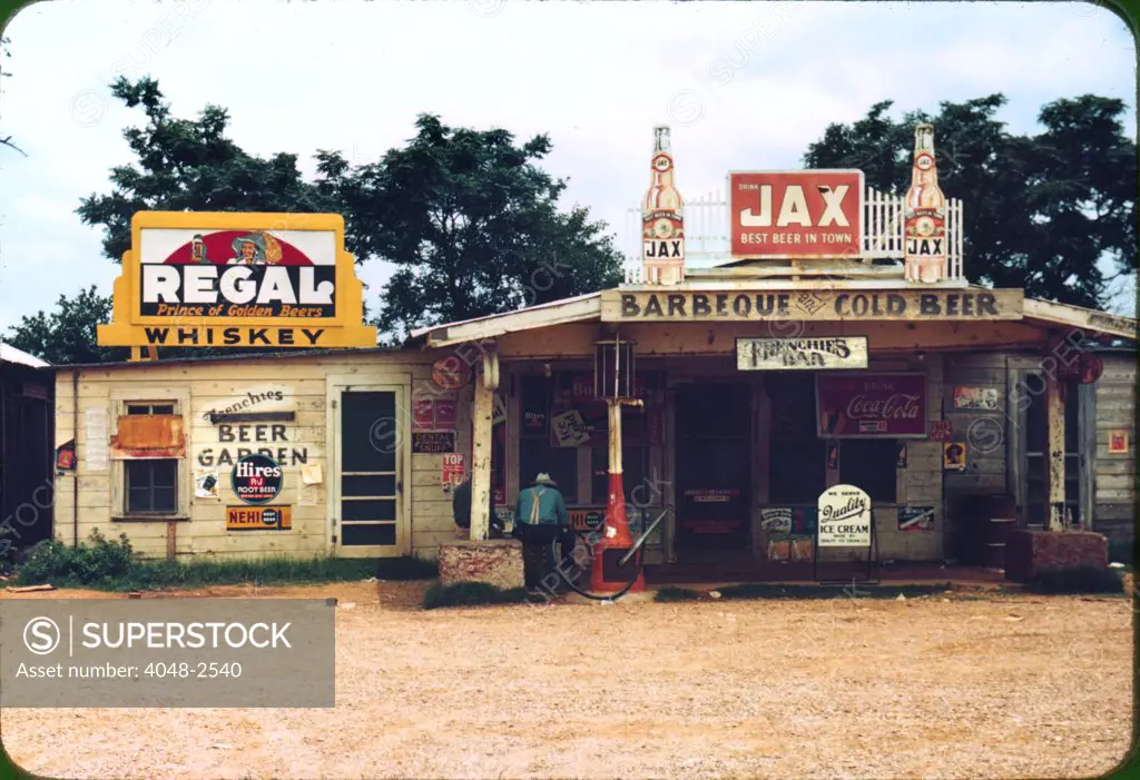 A cross roads store, bar, juke joint, and gas station in the cotton plantation area, Melrose, Louisiana, by Marion Post Wolcott, June, 1940.