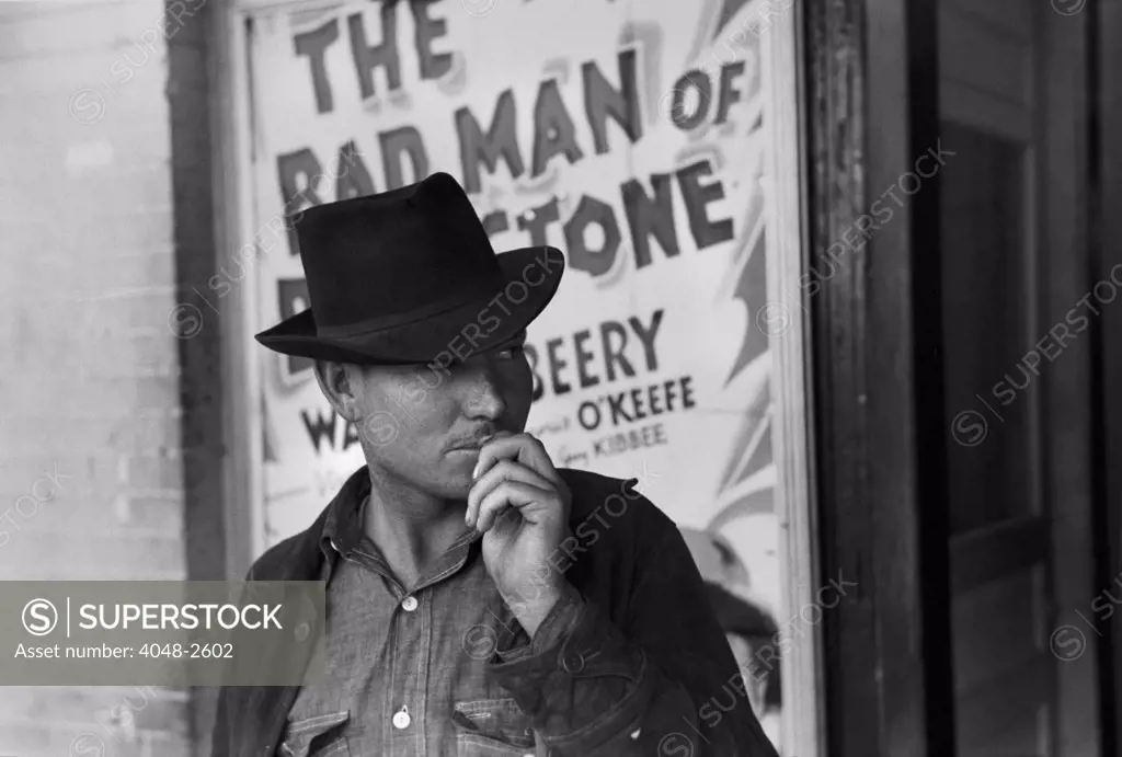 Man in front of a movie theater playing THE BAD MAN OF BRIMSTONE, Waco, Texas, photograph by Lee Russell, 1939.