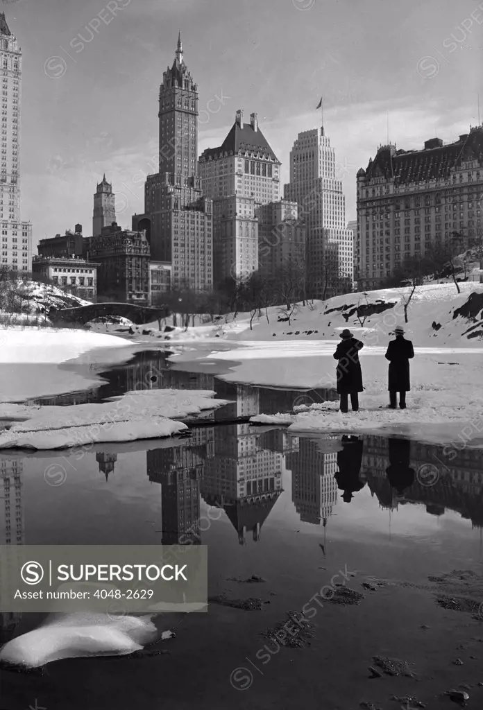 New York City, plaza buildings reflected over park lake, photograph by Samuel H. Gottscho, February 12, 1933.