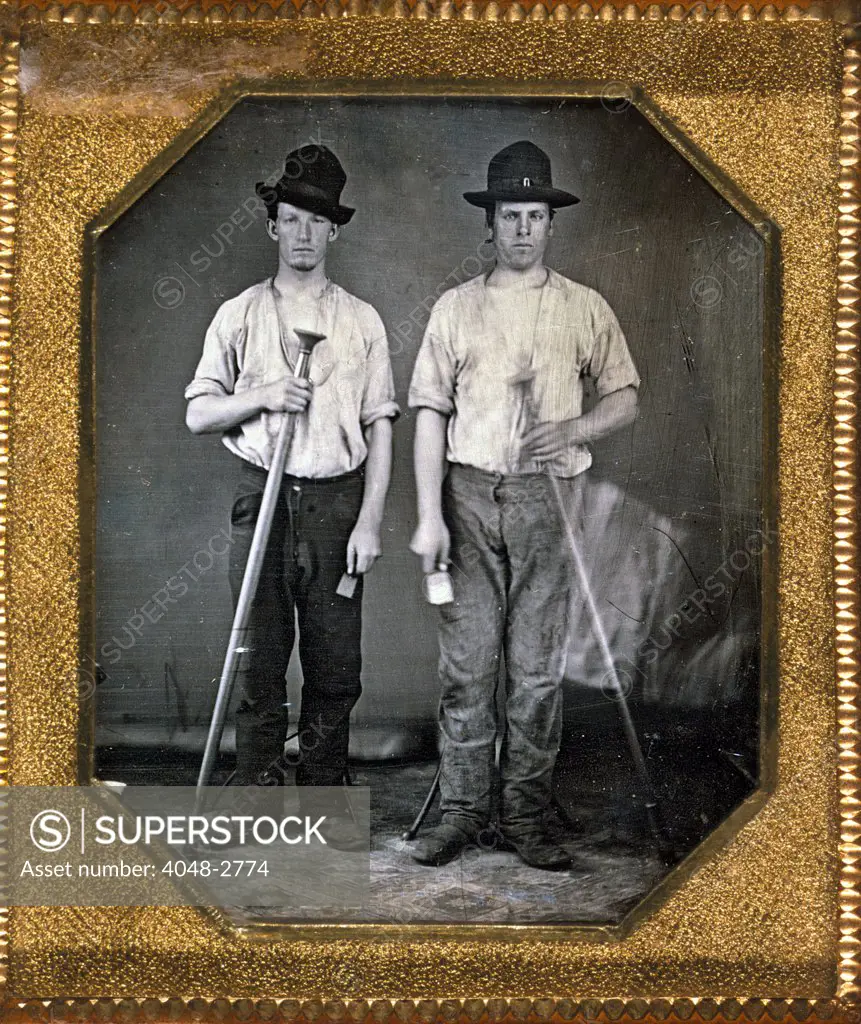 Two men holding floor rammers, foundry tools used for packing sand against molds, sixth-plate daguerreotype, with Eichmeyer variant case, circa 1850.