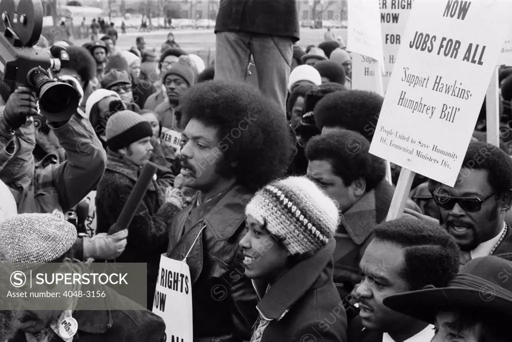 Reverend Jesse Jackson (center, second row), leads a march for jobs around the White House, protesters carry signs advocating support for the Hawkins-Humphrey Bill for employment, Washington DC, photograph by Thomas J. O'Halloran, January 15, 1975.
