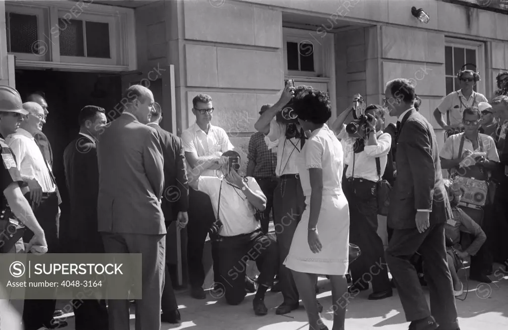 Civil rights, Vivian Malone (front, right of center) entering Foster Auditorium to register for classes at the University of Alabama. The crowd includes photographers, National Guard members and Deputy U.S. Attorney General Nicholas Katzenbach (front, left of center), photograph by Warren K. Leffler, June 11, 1963.