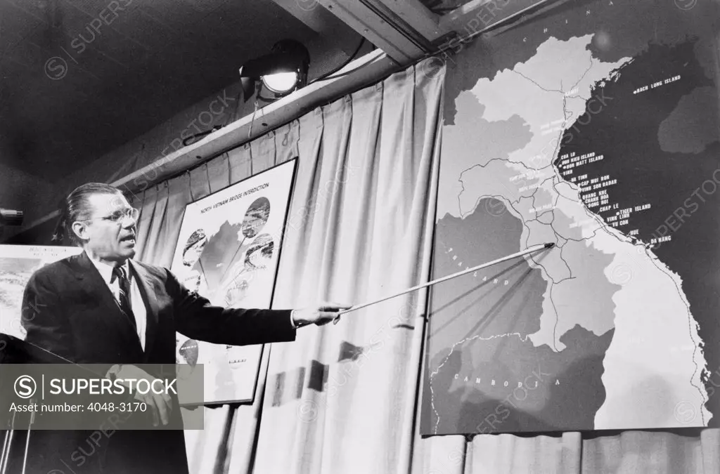Secretary of Defense Robert McNamera pointing to a map of Vietnam at a press conference, photograph by Marion S. Trikosko, April 26, 1965.