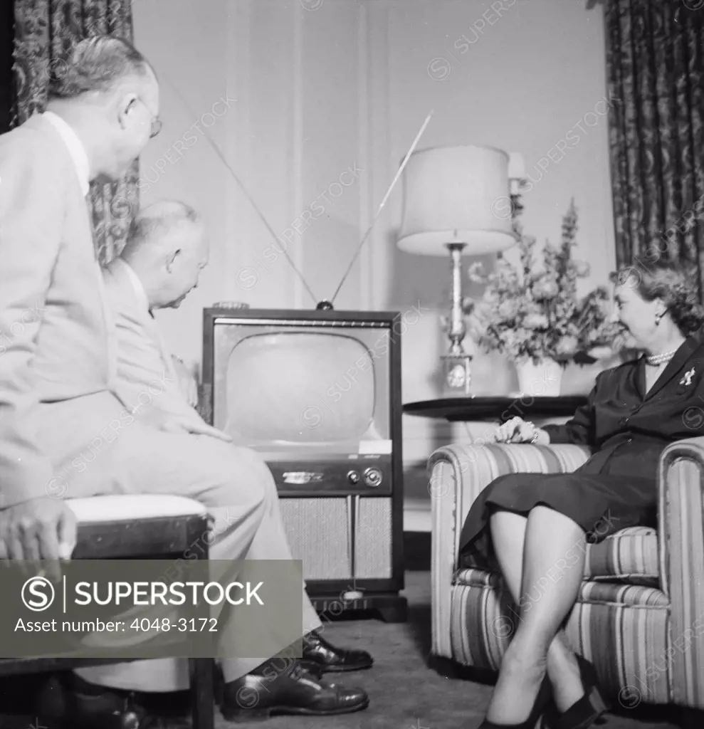 Future President Dwight D. Eisenhower (back left), and future First Lady Mamie Eisenhower, watch the Republican National Convention on television, photograph by Thomas J. O'Halloran, July, 1952.