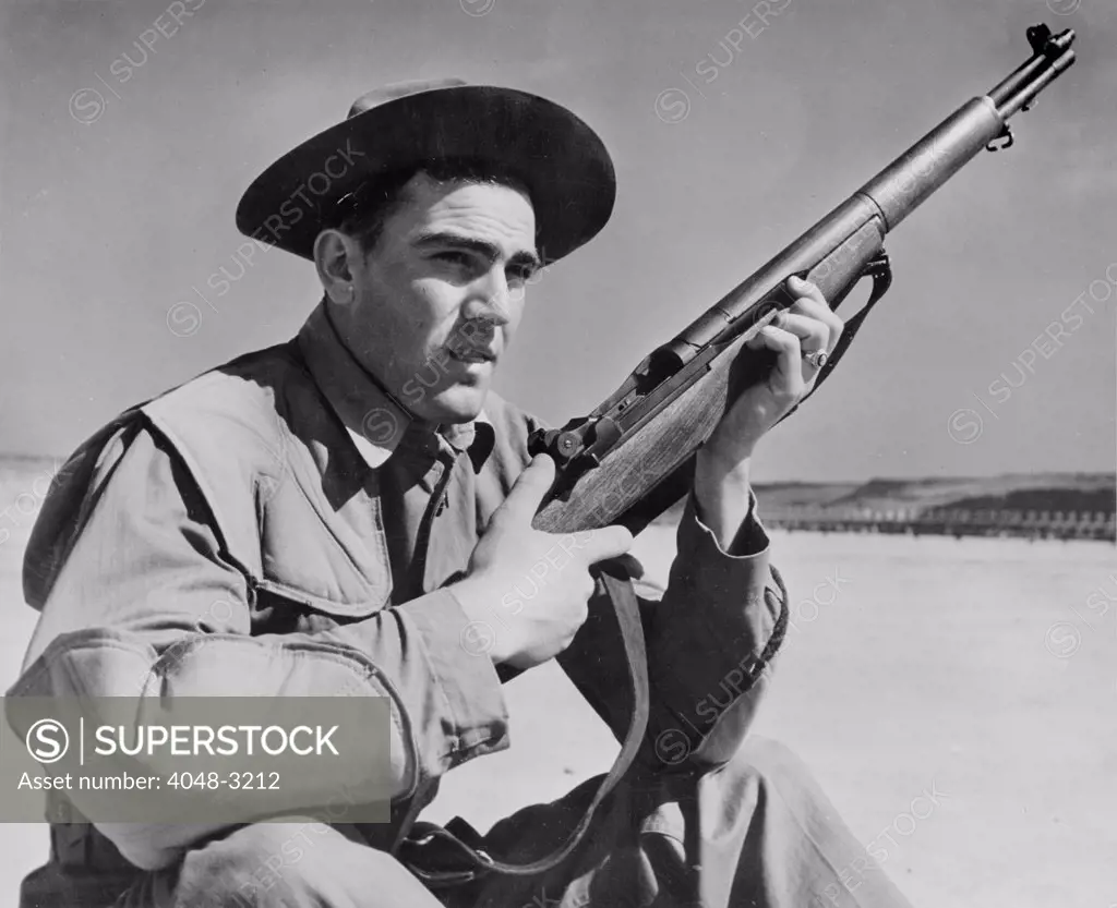 World War II, U.S. soldier ready with rifle, circa 1940-1946.