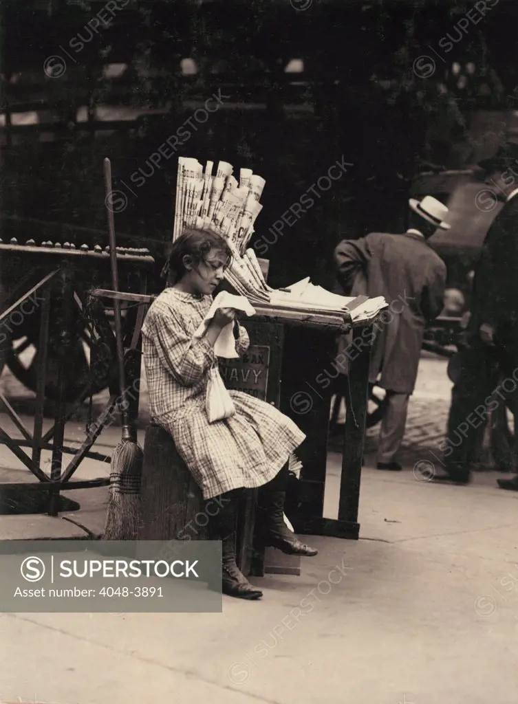 Child labor, Minnie Paster, 10 years old, tending news stand at Bowery and Bond street, New York, photograph by Lewis Wickes Hine, July, 1910.