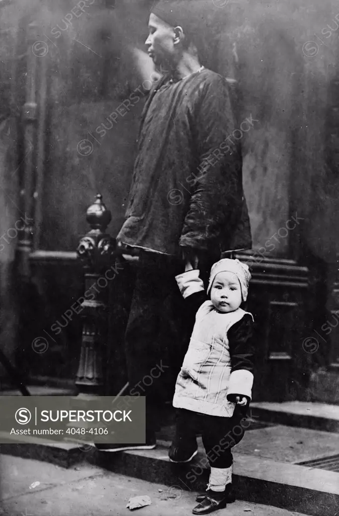 Chinese New Year, Chinese child with an adult on step outside of building, Chinatown, New York City, photograph, 1909.