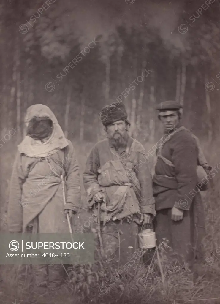 Siberia, Three escaped convicts standing in field, 'original title: 'Runaway Siberian convicts', photograph, 1885-1886.