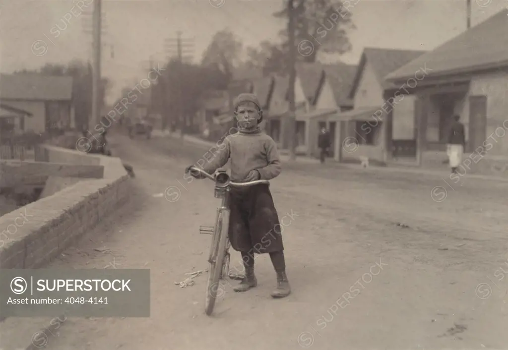 Child labor, Isaac Boyett, 'I'm de whole show', the twelve year old proprietor, manager and messenger of the Club Messenger Service, in the heart of the red Light district where he was delivering messages as he does several times a day. Said he knows the houses and some of the inmates, Texas, photograph by Lewis Wickes Hine, November, 1913.