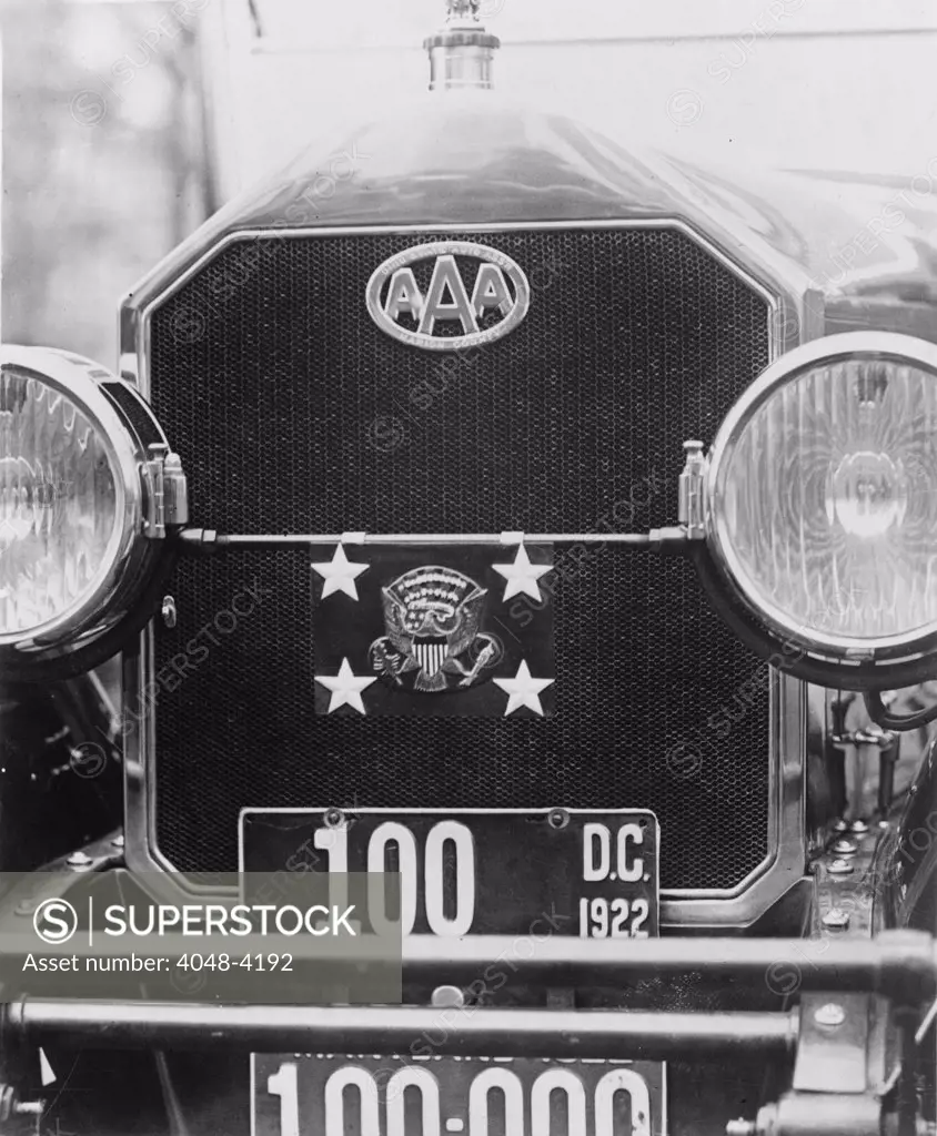 Front grill, bumpers, and headlights of President Warren G. Harding's automobile, showing seal, license plates, and American Automobile Association insignia for the Marion County, Ohio chapter, photograph, circa February 28, 1922