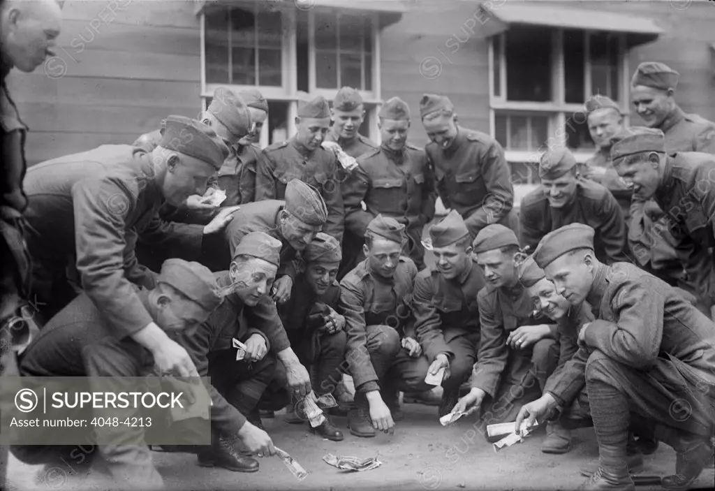 Soldiers playing a dice game, original title: 'Craps at camp', photograph circa 1900s-1930s