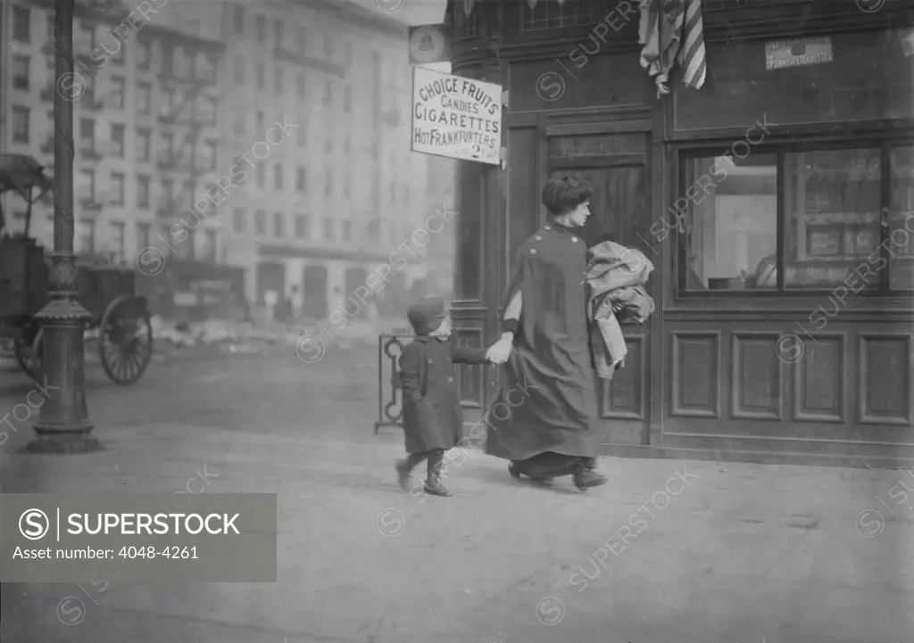 Mother and son carrying homework, near Astor Place, New York City, photograph by Lewis Wickes Hine, February, 1912