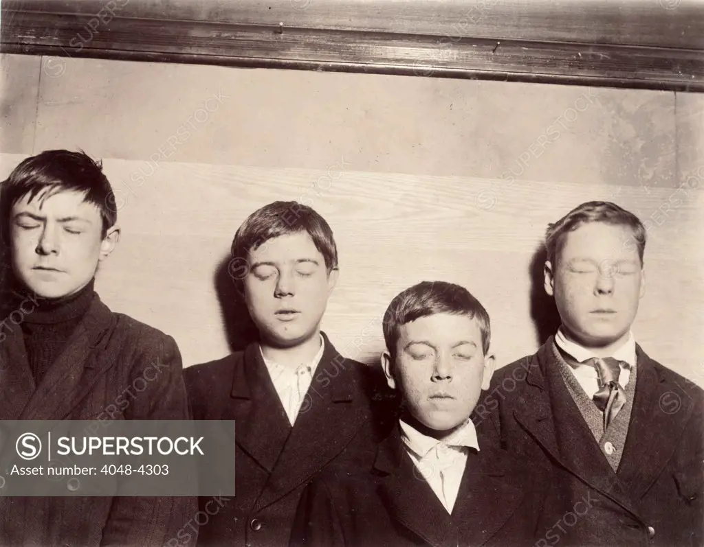Four young men with eyes closed, original caption: 'Four incorrigibles not even reached by the Vocational School', Buffalo, New York, photograph by Lewis Wickes Hine, February, 1910