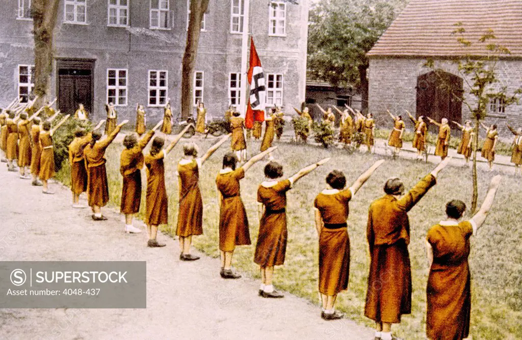 Nazi Germany, Junge Deutsche Madel, giving the Nazi salute, c. 1933.