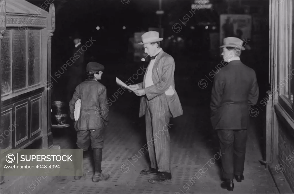 Child labor, original caption: 'Tony Spappos, 349 W. 39th St., N.Y., Selling papers at 10 P.M. at 50th Street & Broadway. About 12 yrs. old.', New York, photograph by Lewis Wickes Hine, January, 1912