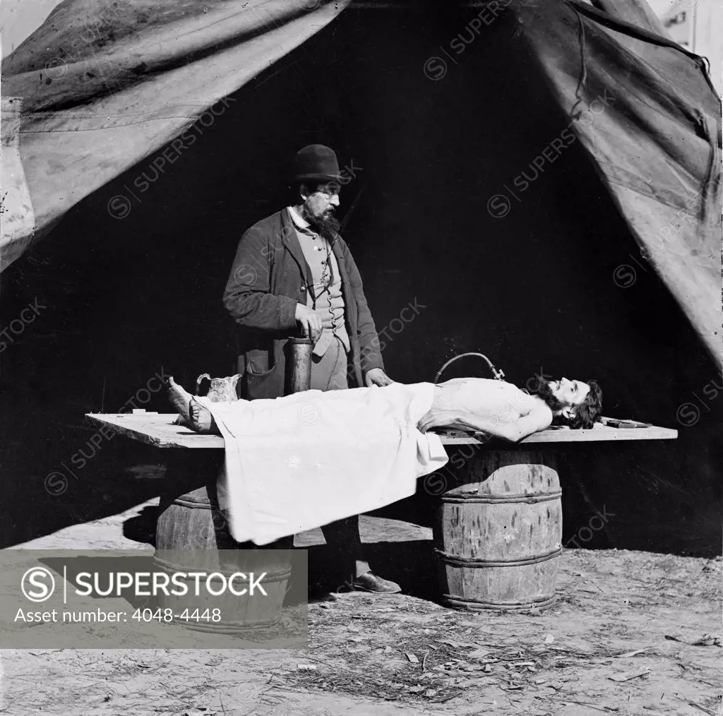 The Civil War, embalming surgeon at work on soldier's body, photograph, 1860-1865