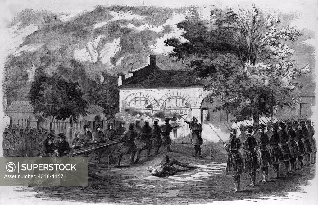 Harper's Ferry. The U.S. Marines storming the engine house--Insurgents firing through holes in the doors. Woodcut, ca 1859