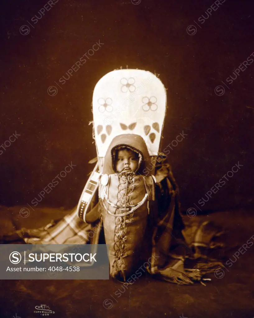 Nez Percé infant in cradleboard. Edward S. Curtis, 1899