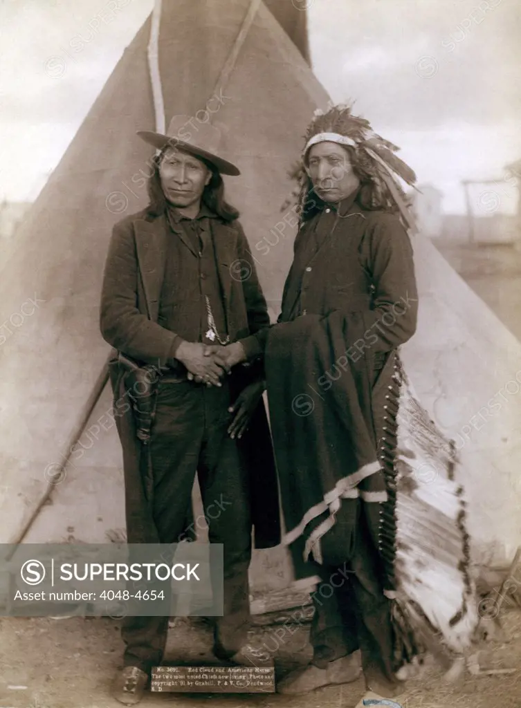 Three Cheyenne men, Standing Elk, No. 1; Running Hog, No. 2; Little Wolf, No. 3, wearing ceremonial clothing and holding rifles with Col. Oelrich, No. 4; Interpreter, No. 5. Dakota Territory. photo by John C. Grabill, 1887
