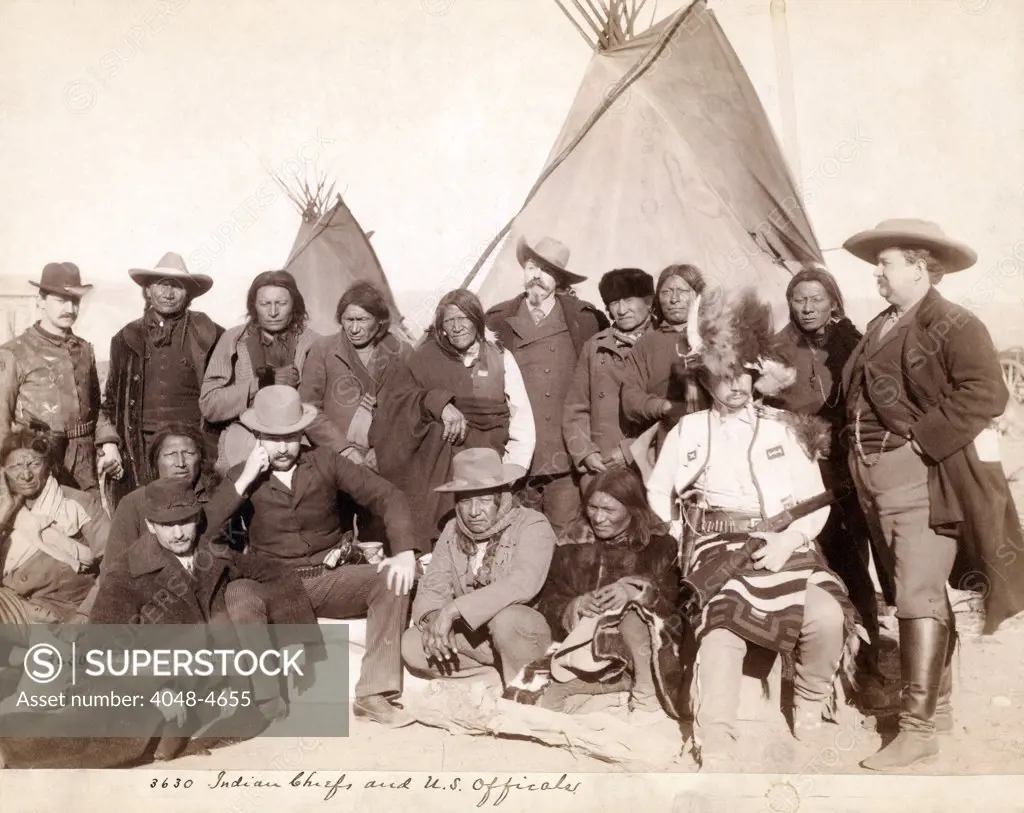 Lakota (Brulé, Miniconjou, and Oglala) chiefs and U.S. officials in front of tipis at Pine Ridge Reservation. Pine Ridge, South Dakota.  Photo by John C. Grabill. 1891