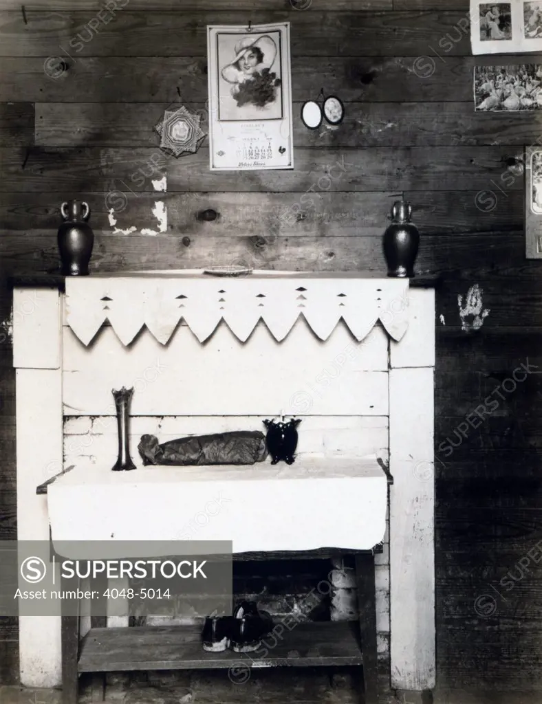 Fireplace in the bedroom of Floyd Burroughs, cotton sharecropper, Hale County, Alabama. Hale County, Alabama. Published in the book, 'Let Us Now Praise Famous Men'. photograph by Walker Evans, 1936.