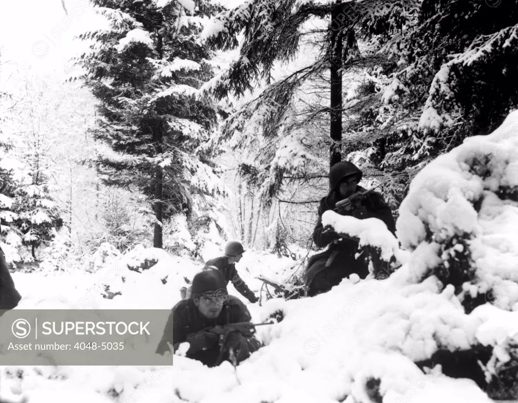 World War II. US Army infantrymen take cover in the snow in the Ardennes, Belgium. Dec 1944-January 1945.