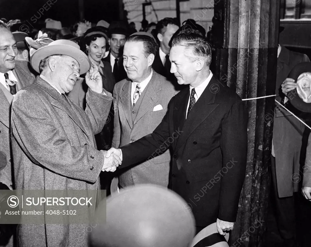 Vice President-elect Alben W. Barkley (l) shakes hands with James V. Forrestal, with others looking on. ca. 1948