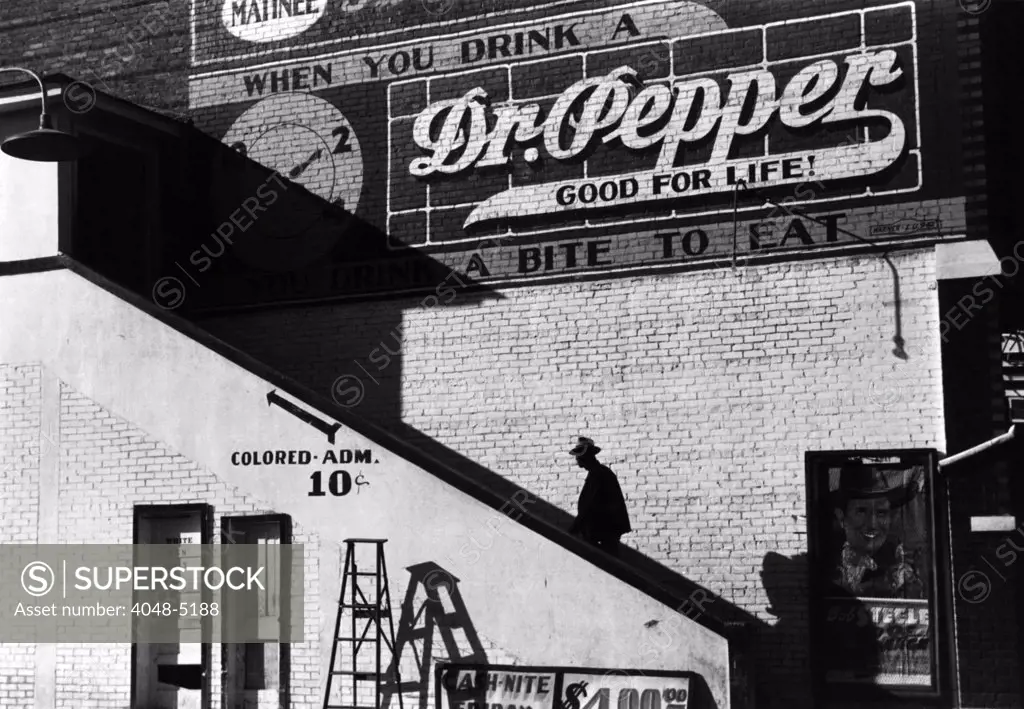 Negro going in colored entrance of movie house on Saturday afternoon, by Marion Post Wolcott, Belzoni, Mississippi Delta, Mississippi, 1939.
