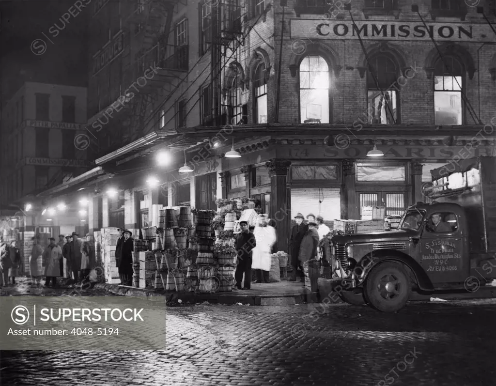 New York City street at night, circa late 1930s.