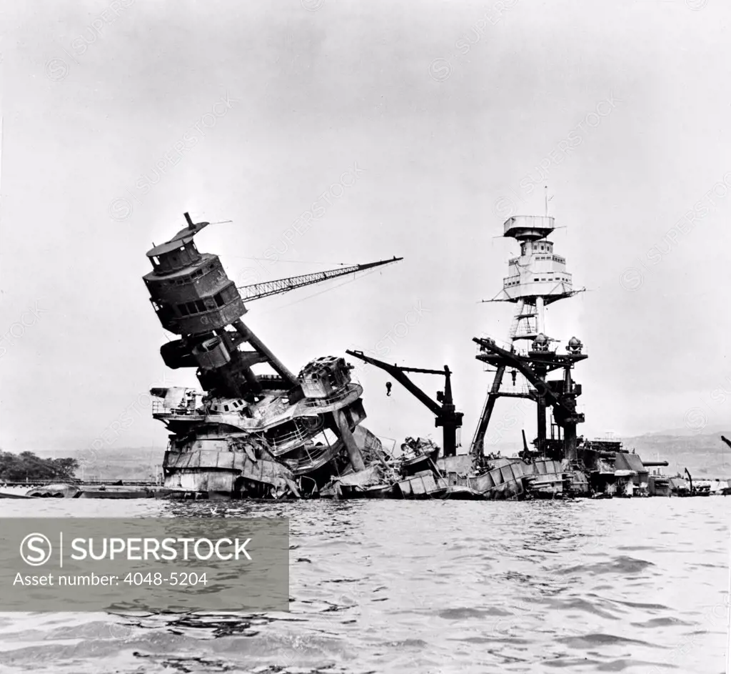 After the fire. Battered by aerial torpedoes and bomb hits, the USS Arizona rests on the bottom of Pearl Harbor. December 7, 1941