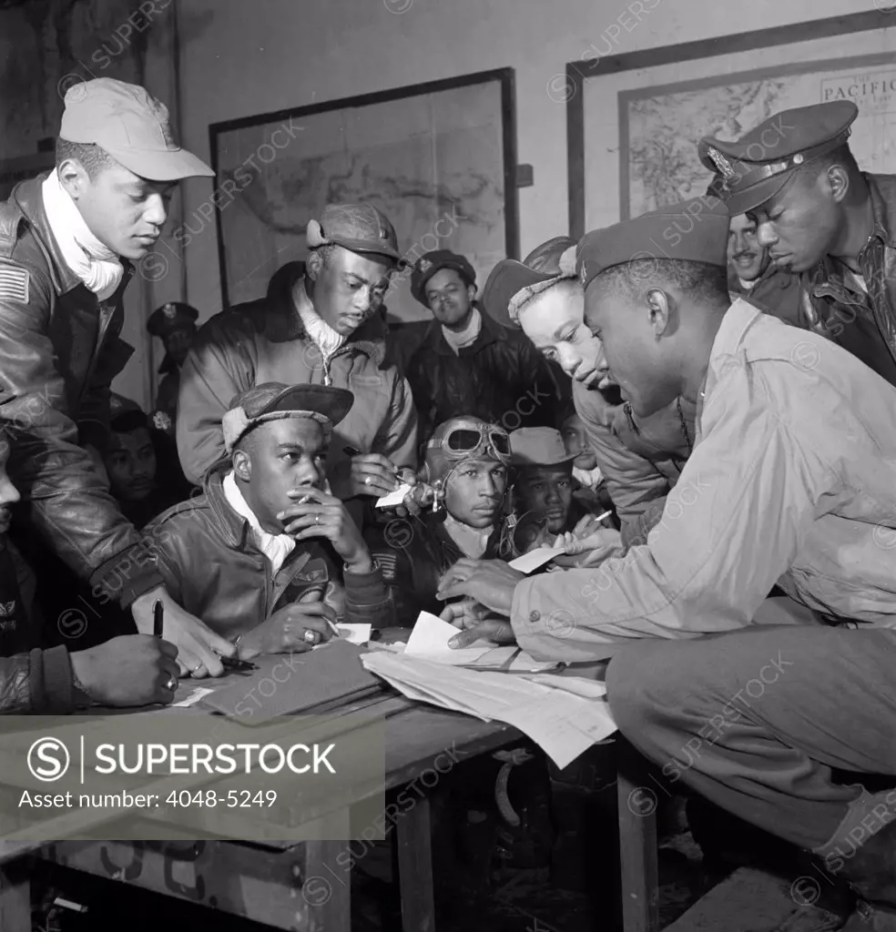 Preflight briefing of several Tuskegee airmen at Ramitelli, Italy, March 1945.  Photograph by Toni Frissell.