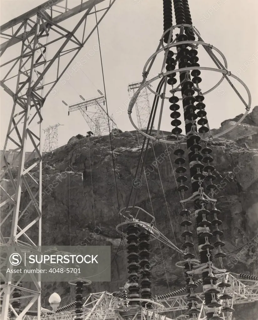 Power station towers and cables at the Hoover Dam, Arizona and Nevada was the world's largest electric-power generating station when it was completed in 1936. It provided energy to the American southwest but cut river flow to the Colorado River Delta in Mexico. 1941 photo.