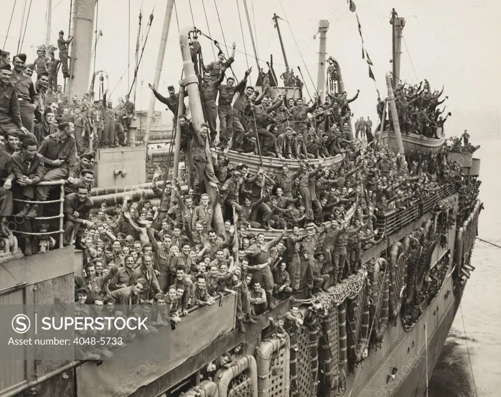 After victory in Europe, the Troops of the 20th Armored Division and units of the 9th Army whoop it up as the SS John Ericsson nears it pier on New York City's Hudson River. August 6, 1945.