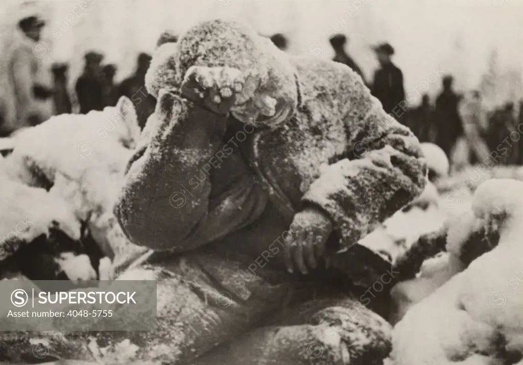 Dead Russian soldier sitting, covered with a dusting of snow, a casualty of the Battle of Suomussalmi, during the Russo-Finnish War of 1939-40.