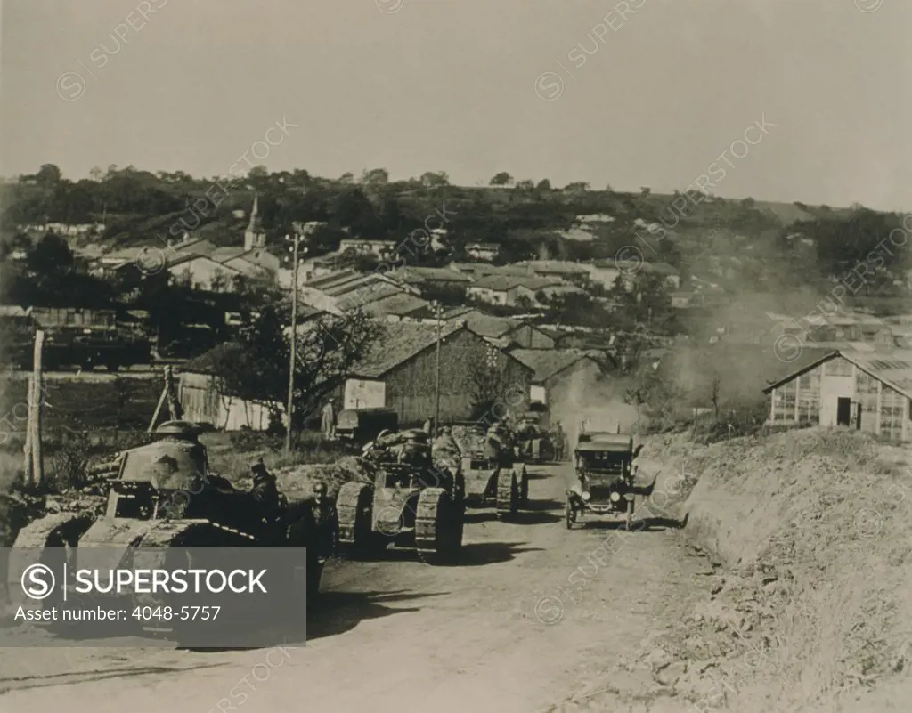 French tanks passing through Rampont, France, in the last month of World War I. The armored vehicles were introduced to break the deadlock of the trench warfare of the Western front. Oct 10/18