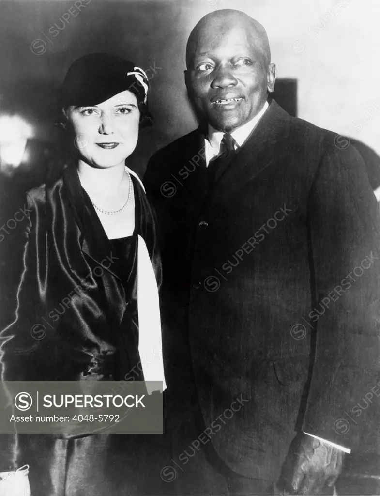 Former heavyweight boxing champion, Jack Johnson, with his fourth wife, the former Irene Pineau, at the opening of his night club, 'The Showboat,' Los Angeles, California. Oct 7, 1931.