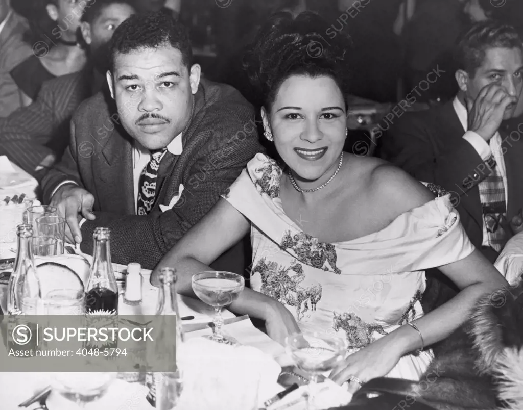 Heavyweight champ Joe Louis and his first wife Marva dining at a night club in 1947.
