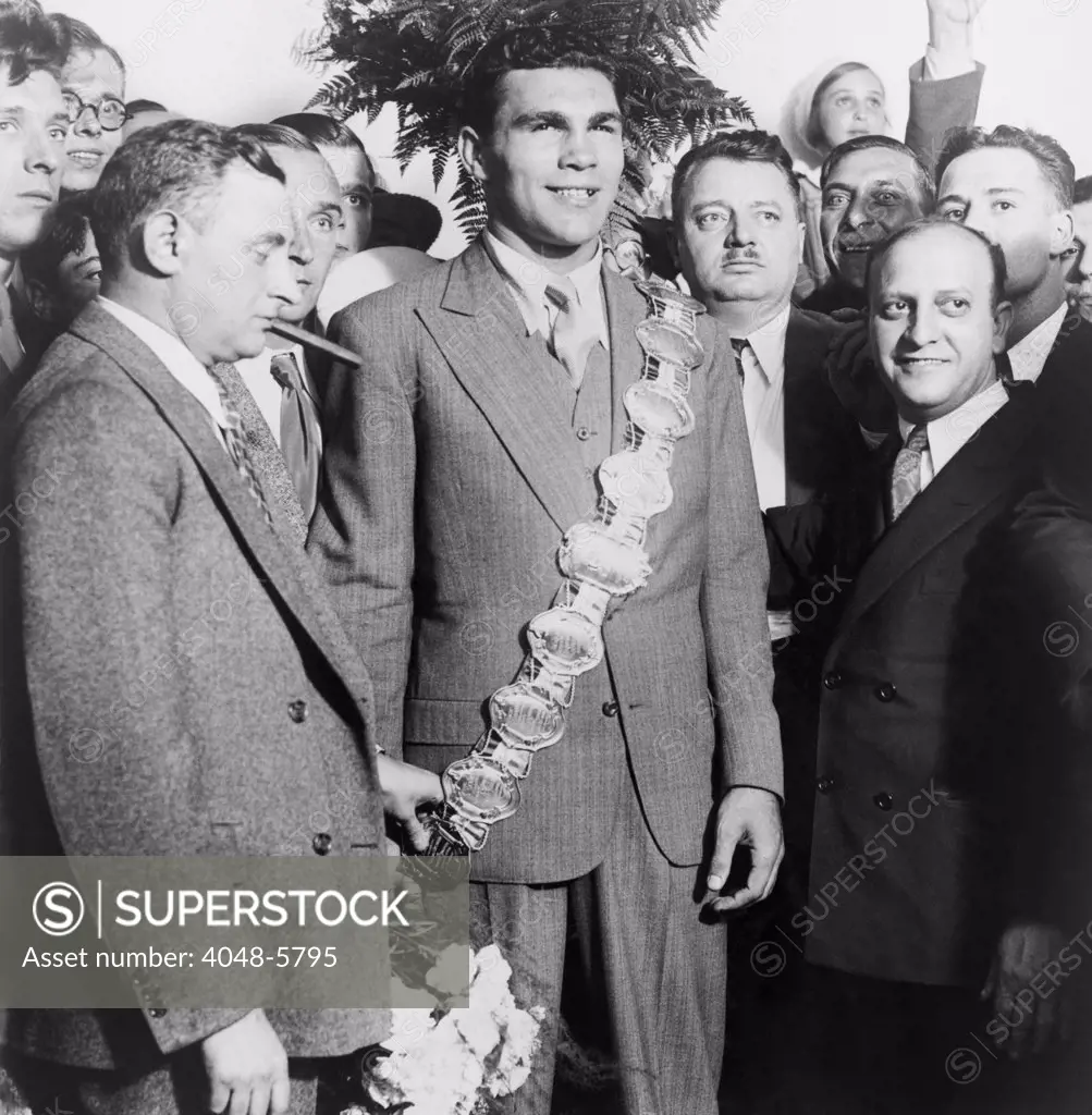 Max Schmeling (1905-2005), wearing heavyweight belt, flanked by his manager Joe Jacobs and Nat Fleischer (right), editor of the boxing magazine, RING.
