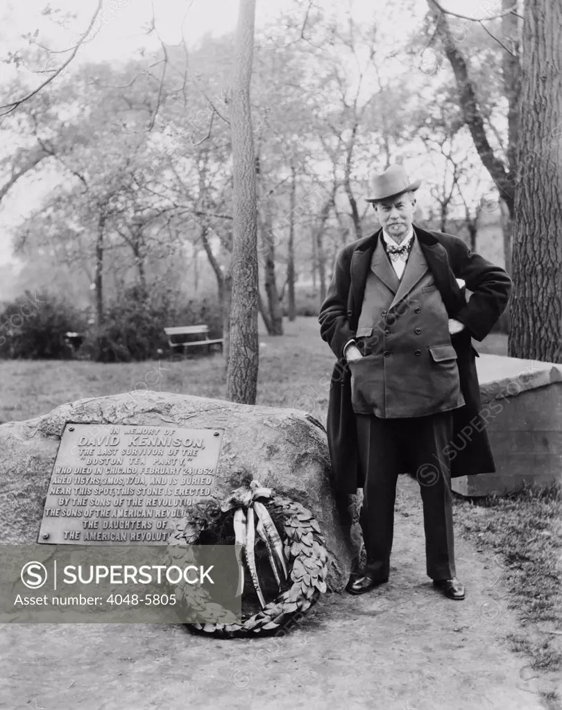 Sir Thomas J. Lipton, (1848-1931), the creator of the famous LIPTON TEA brand, next to memorial to David Kennison, last survivor of the Boston Tea Party. He is also famous for this five unsuccessful attempts to win the America's Cup yacht race. Ca. 1927.