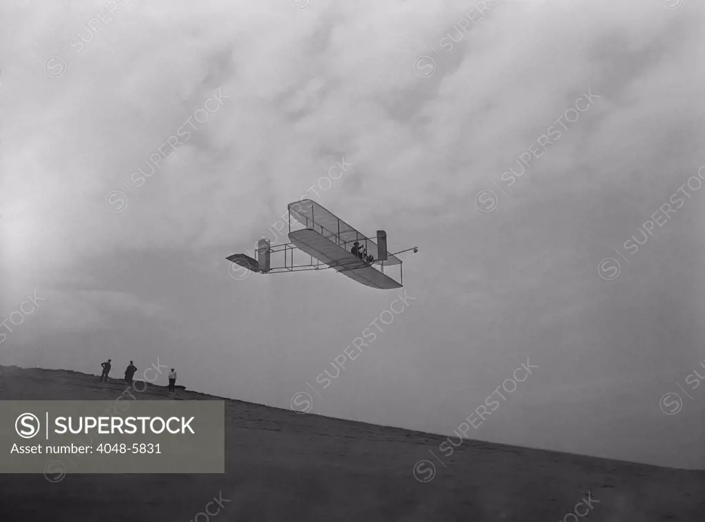 Wilbur Wright pilots a glider during Wright Brothers' flight experiments at Kitty Hawk, North Carolina. Ca. 1902.