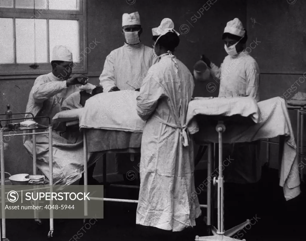 Operation at the U.S. Army Camp Hospital in Winchester, England during World War I. Anesthesia is administered by dripping ether or chloroform onto a cloth over the patients nose. 1918.
