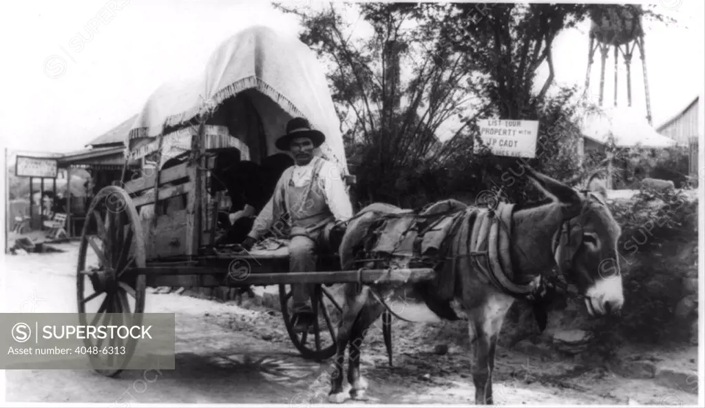 Mexican man on a donkey cart emigrating to the United States via Nuevo Laredo, directly across the Rio Grande River from Laredo, Texas. Ca. 1912.